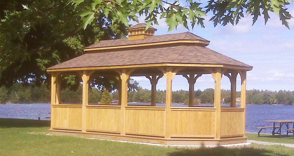 large oval wooden gazebo by the river